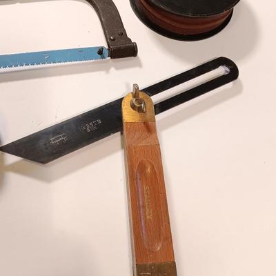 Pro series 25-foot tape measure - Hack saw - Emery cloth roll - and a Stanley adjustable bevel Angle