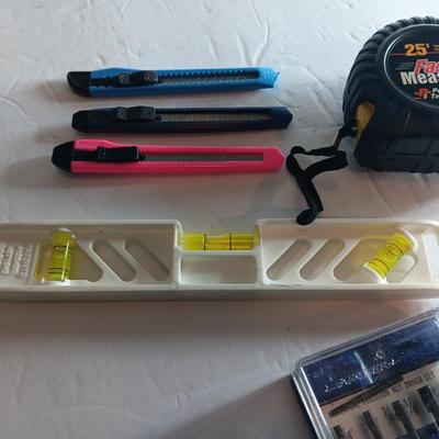 Assortment of hand tools - tape measure - utility knives - level - precision screwdriver set and more
