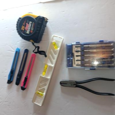 Assortment of hand tools - tape measure - utility knives - level - precision screwdriver set and more