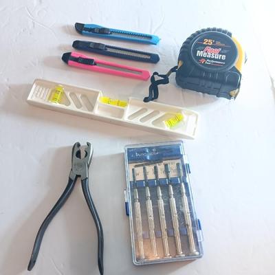 Assortment of hand tools - tape measure - utility knives - level - precision screwdriver set and more