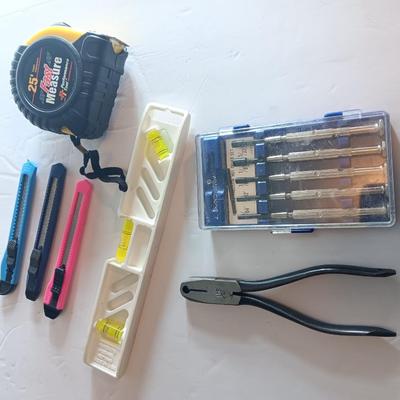 Assortment of hand tools - tape measure - utility knives - level - precision screwdriver set and more
