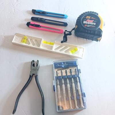 Assortment of hand tools - tape measure - utility knives - level - precision screwdriver set and more