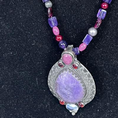 Pretty Purple, Pink, Reddish Beads and Silver Pendant with set Stones. 
