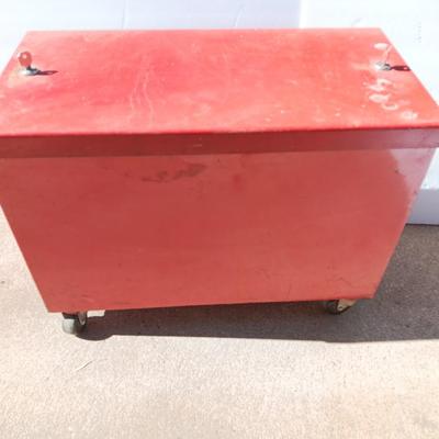 Locking metal box lined with Masonite wood.