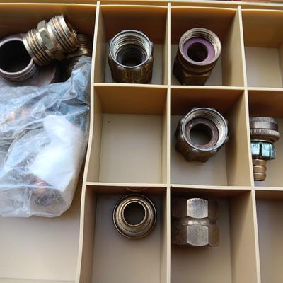 Plano plastic storage cases with an assortment of brass fittings - hose repair and springs