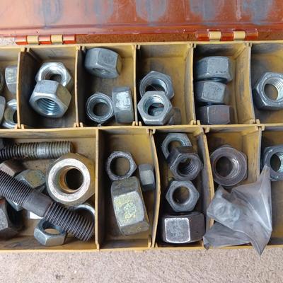 Plano plastic storage cases with an assortment of nuts and bolts