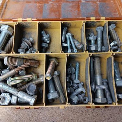 Plano plastic storage cases with an assortment of nuts and bolts