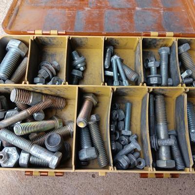 Plano plastic storage cases with an assortment of nuts and bolts