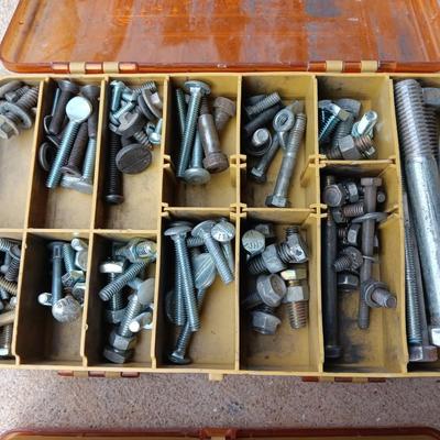 Plano plastic storage cases with an assortment of nuts and bolts