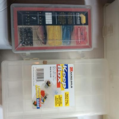 Plastic Plano fishing tackle organizing boxes and others.
