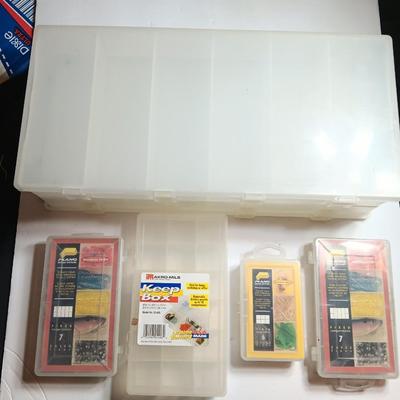 Plastic Plano fishing tackle organizing boxes and others.