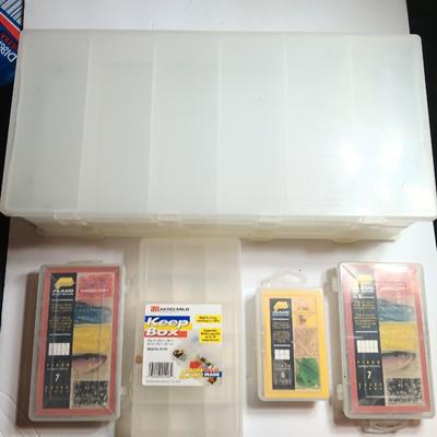 Plastic Plano fishing tackle organizing boxes and others.