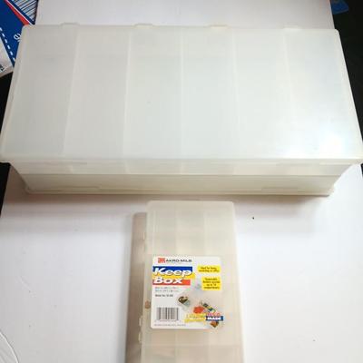 Plastic Plano fishing tackle organizing boxes and others.