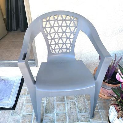 2 Gray Outdoor Chairs with 2 Potted Plants