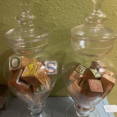 2 tall glass jars with vintage blocks