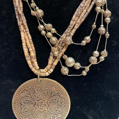 Large pendant and gold bead necklaces