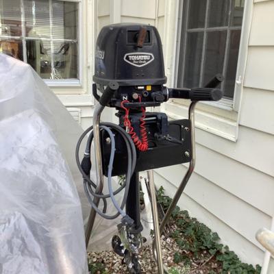 O764 Tohatsu 4 Strike Outboard Motor on cart / stand with gas tank