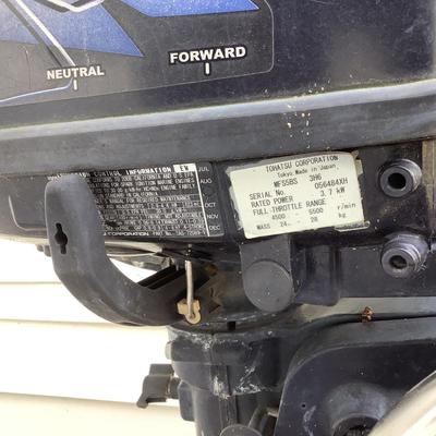 O764 Tohatsu 4 Strike Outboard Motor on cart / stand with gas tank