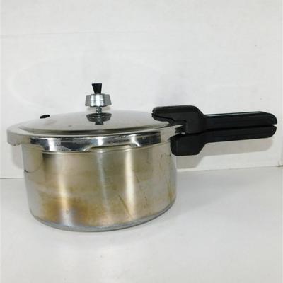 164 Presto Pressure Cooker With Pressure Regulator. Includes Instructions and Recipes 1990 15 x 17 1/2 approx.