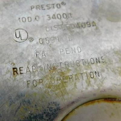 164 Presto Pressure Cooker With Pressure Regulator. Includes Instructions and Recipes 1990 15 x 17 1/2 approx.