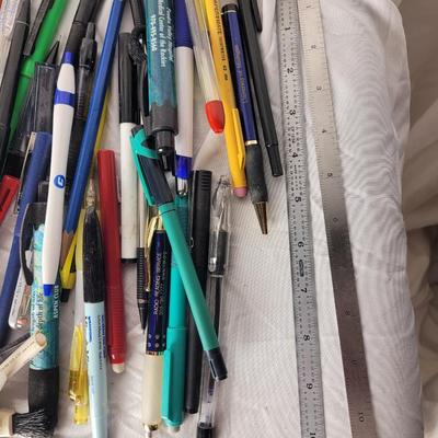 Lot of mechanical pencils, lead refills, sharpies, promotional pens, rulers and erasers.