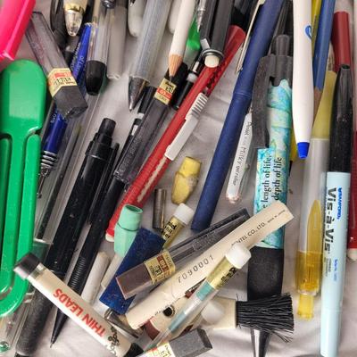 Lot of mechanical pencils, lead refills, sharpies, promotional pens, rulers and erasers.