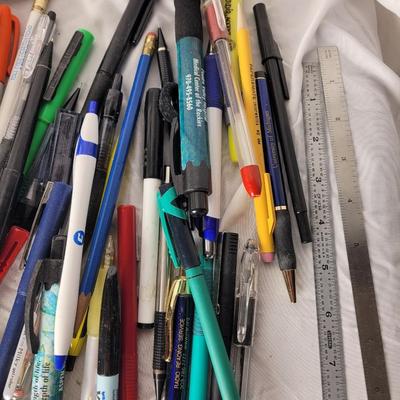 Lot of mechanical pencils, lead refills, sharpies, promotional pens, rulers and erasers.