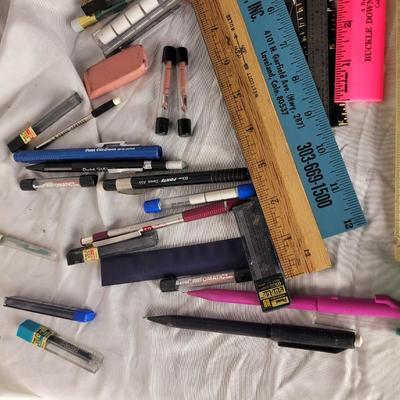 Lot of mechanical pencils, rulers, erasers, lead refills and thumbtacks.