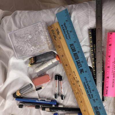 Lot of mechanical pencils, rulers, erasers, lead refills and thumbtacks.