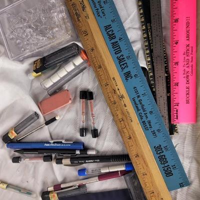 Lot of mechanical pencils, rulers, erasers, lead refills and thumbtacks.