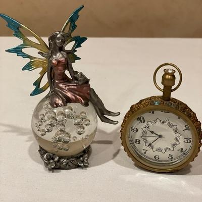 Fairy on glass ball and large pocket watch style clock