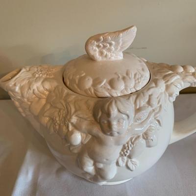 Vintage white tea pot with cherubs