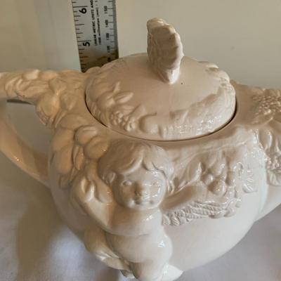 Vintage white tea pot with cherubs