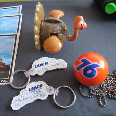 Lot 379: Misc Junk Drawer Lot, Postcards, Leach Keyrings, 76 Antenna Topper, More