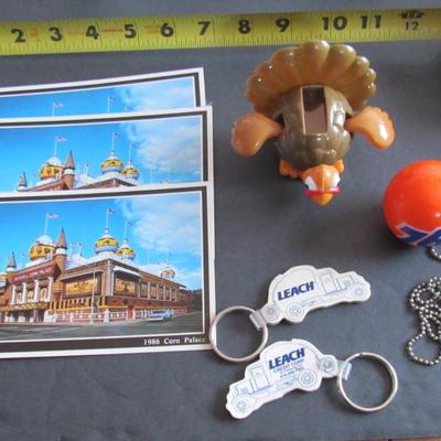 Lot 379: Misc Junk Drawer Lot, Postcards, Leach Keyrings, 76 Antenna Topper, More