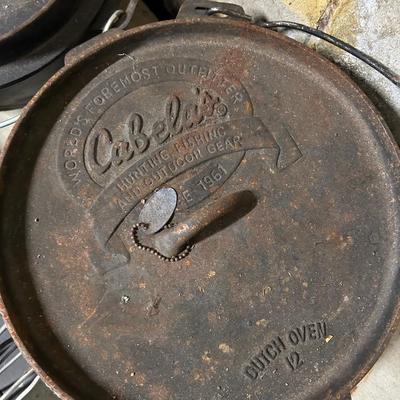 LOT 67: Outdoor Cooking - Two Cabela's Cast Iron Dutch Ovens and More