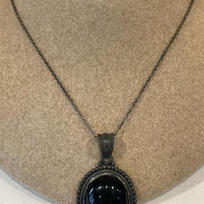 Black pendant stamped Thai. 925 and bracelet
