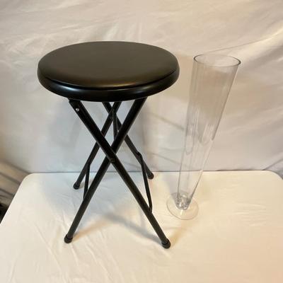 Tall glass vase, black stool