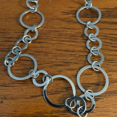Group of silver color circle necklaces, Chicos
