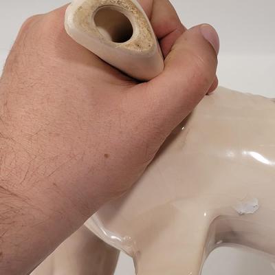 Porcelain or Chalkware, painted / glazed dog from Brazil