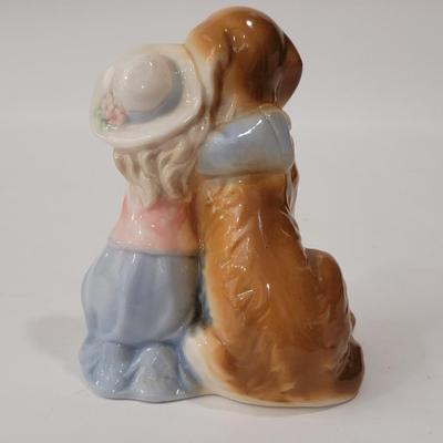 Small figurine girl and dog.