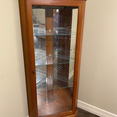 Corner lighted curio oak cabinet with glass shelves