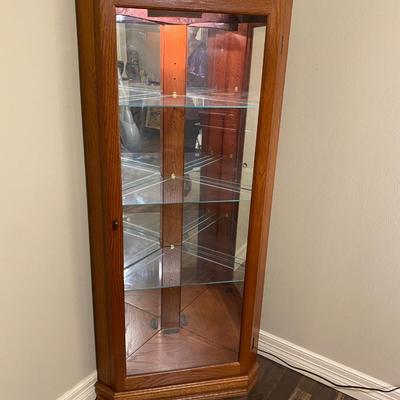 Corner lighted curio oak cabinet with glass shelves