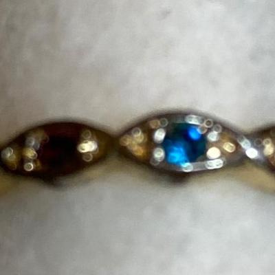 Thin goldtone ring with multicolored stones. Size 7