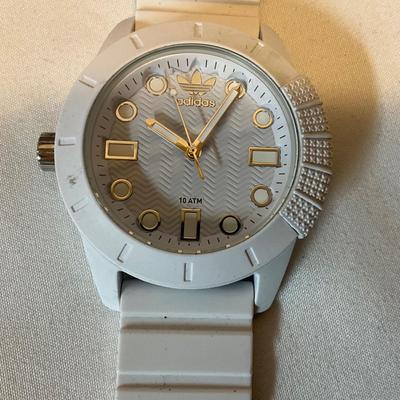 Reduce water cooler, adidas watch, gray bag