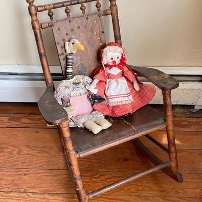 LOT 33: Antique / Vintage Children's Wooden Rocking Chair with Pockets of Learning and Mother Goose Dolls
