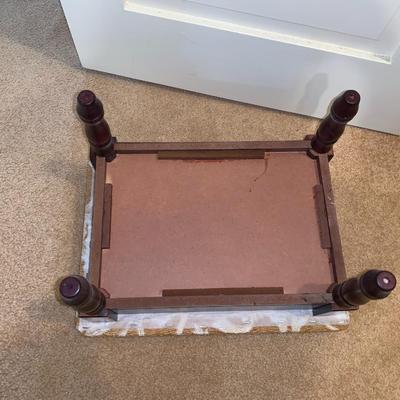 small upholstered footstool with hinged top