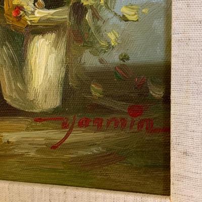 Gold framed oil painting with accent light
