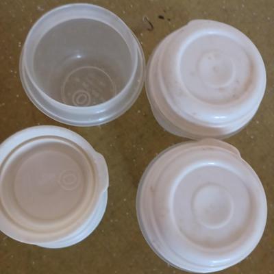 3 cream tupperware containers