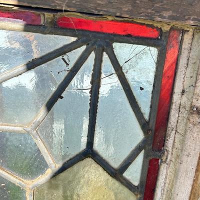 Antique leaded, stained glass windows, one needs repair.